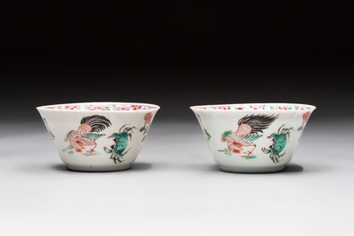A Chinese famille rose 'roosters' covered teapot and two cups and saucers, Yongzheng