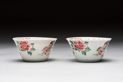 A Chinese famille rose 'roosters' covered teapot and two cups and saucers, Yongzheng