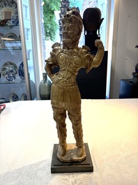 A Chinese stoneware cream-glazed sculpture of a warrior, possibly Tang