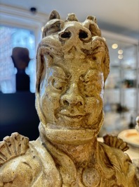 A Chinese stoneware cream-glazed sculpture of a warrior, possibly Tang