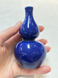 Three Chinese blue-glazed miniature vases on wooden stands and a claire-de-lune seal paste box and cover, 19th C.