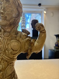 A Chinese stoneware cream-glazed sculpture of a warrior, possibly Tang
