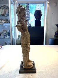 A Chinese stoneware cream-glazed sculpture of a warrior, possibly Tang