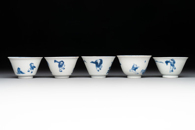 Five Chinese blue and white 'elegant beauty and boy' cups and saucers, Chenghua mark, Kangxi