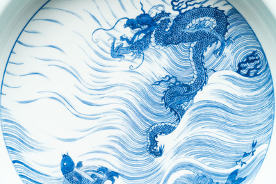 A rare large imperial Chinese blue and white 'dragon and carps' basin, Kangxi mark and of the period