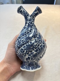 A Chinese blue and white double-spouted swirling-lobed cruet, Kangxi