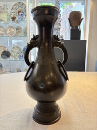 A large Chinese bronze 'hu' vase with luduan-form handles, Yuan