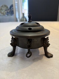 A Chinese bronze tripod censer and cover, Sui/Tang