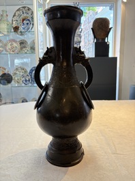 A large Chinese bronze 'hu' vase with luduan-form handles, Yuan