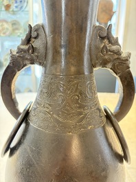 A large Chinese bronze 'hu' vase with luduan-form handles, Yuan