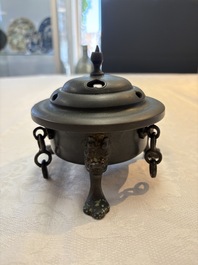 A Chinese bronze tripod censer and cover, Sui/Tang