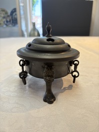 A Chinese bronze tripod censer and cover, Sui/Tang