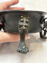 A Chinese bronze tripod censer and cover, Sui/Tang