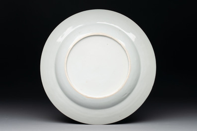 A rare Chinese Dutch-decorated famille rose 'Brussels Clothtraders' plate, Qianlong, ca. 1740-1750