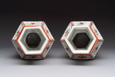 A pair of Chinese famille rose reticulated double-walled 'mandarin subject' vases, Qianlong