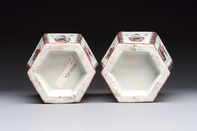A pair of Chinese famille rose reticulated double-walled 'mandarin subject' vases, Qianlong