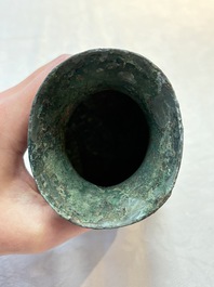 A Chinese archaic bronze food vessel and cover with taotie design, 'zhi 觶', Shang