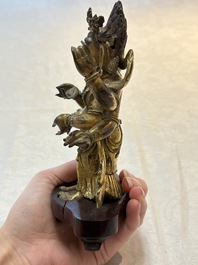 A Sino-Tibetan gilt-bronze figure of White Mahakala on wooden stand, 18th C.