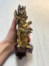 A Sino-Tibetan gilt-bronze figure of White Mahakala on wooden stand, 18th C.