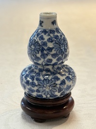 A Chinese blue and white double-gourd snuff bottle and a huali snuff bottle, Xuande and Qianlong mark, 18th C.