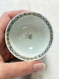 A pair of Chinese grisaille and iron-red 'landscape' cups and saucers, Yongzheng/Qianlong