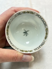 A pair of Chinese grisaille and iron-red 'landscape' cups and saucers, Yongzheng/Qianlong