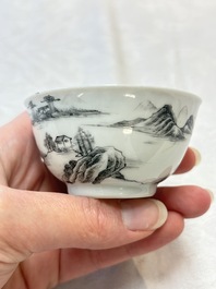 A pair of Chinese grisaille and iron-red 'landscape' cups and saucers, Yongzheng/Qianlong