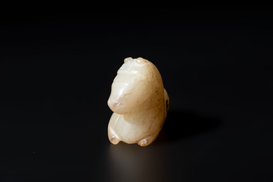A Chinese white and russet jade pendant in the form of a horse, Song/Ming