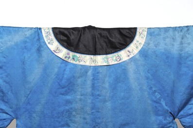 A rare Chinese blue-ground embroidered silk 'butterflies and flowers' robe, lined with fur, 19th C.