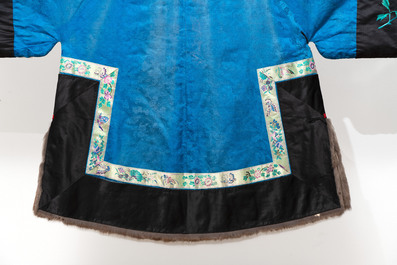 A rare Chinese blue-ground embroidered silk 'butterflies and flowers' robe, lined with fur, 19th C.
