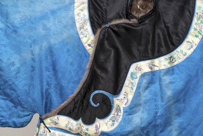 A rare Chinese blue-ground embroidered silk 'butterflies and flowers' robe, lined with fur, 19th C.
