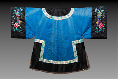 A rare Chinese blue-ground embroidered silk 'butterflies and flowers' robe, lined with fur, 19th C.