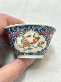 A Chinese famille rose blue-ground cup and saucer, and a 'faux-bois' cup and saucer, Yongzheng/Qianlong
