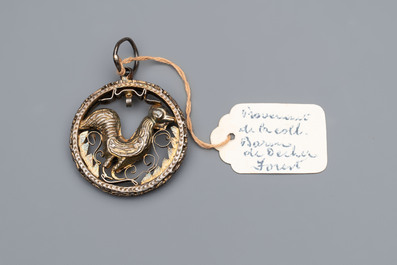 A gilt-brass 'Rooster' amulet with glass-inlaid eyes, 17th C. or later