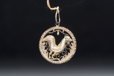 A gilt-brass 'Rooster' amulet with glass-inlaid eyes, 17th C. or later