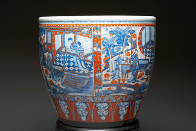A large Chinese European-decorated blue and white fish bowl with narrative design, on a later wooden stand, Kangxi