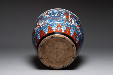 A large Chinese European-decorated blue and white fish bowl with narrative design, on a later wooden stand, Kangxi