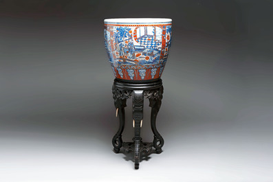A large Chinese European-decorated blue and white fish bowl with narrative design, on a later wooden stand, Kangxi