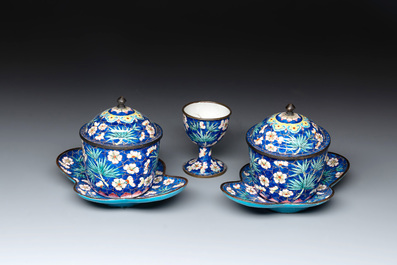 A pair of Chinese blue-ground Canton enamel covered bowls on stands and an egg cup, Qianlong/Jiaqing