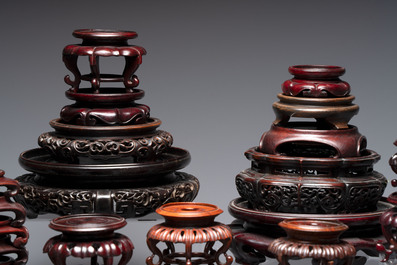 A collection of 45 Chinese wooden stands, 19/20th C.