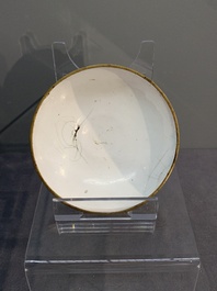 A Chinese Canton enamel 'foreigners' bowl and cover and an 'erotical subject' plate, Yongzheng/Qianlong