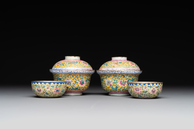 A pair of Chinese yellow-ground Canton enamel covered bowls and two cups, Yongzheng/Qianlong