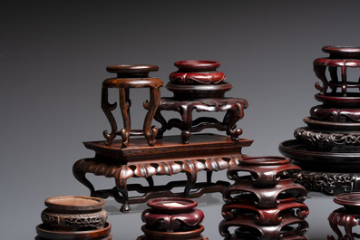 A collection of 45 Chinese wooden stands, 19/20th C.
