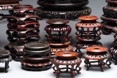 A collection of 45 Chinese wooden stands, 19/20th C.