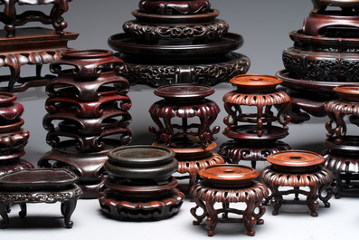 A collection of 45 Chinese wooden stands, 19/20th C.