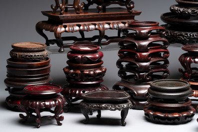 A collection of 45 Chinese wooden stands, 19/20th C.