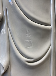A large Chinese Dehua blanc de Chine figure of Buddha holding a lotus, He Chaozong 何朝宗 and Dehua 德化 mark, 20th C.