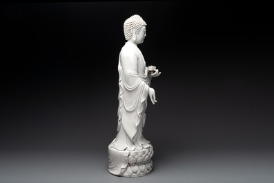 A large Chinese Dehua blanc de Chine figure of Buddha holding a lotus, He Chaozong 何朝宗 and Dehua 德化 mark, 20th C.