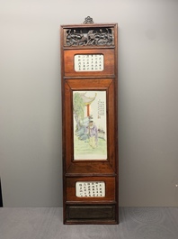 A Chinese carved wooden panel with famille rose plaques in the style of Wang Qi 王琦, dated 1932