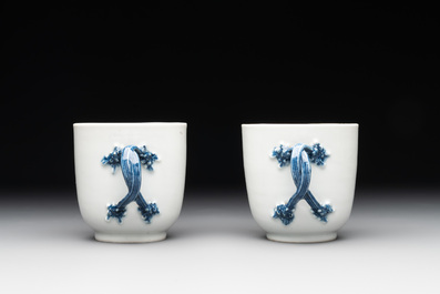 A pair of Chinese blue and white handled cups and saucers and a milk jug, Qianlong/Jiaqing